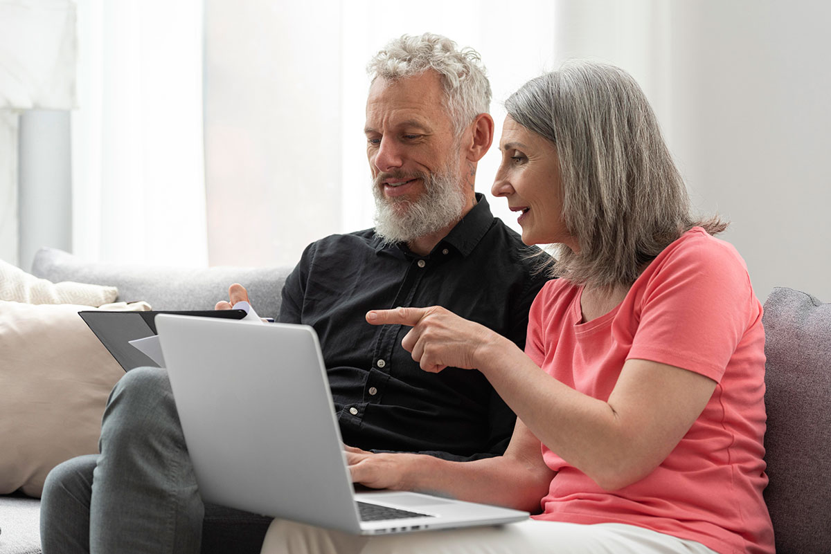 8 Remarkable Benefits of Bioidentical Hormone Replacement Therapy older couple home couch using laptop